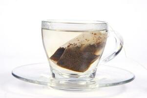 a glass cup with a tea bag in it photo