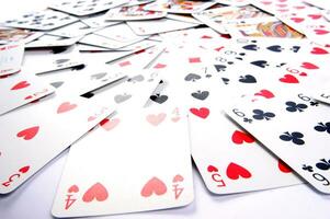 a pile of playing cards on a table photo