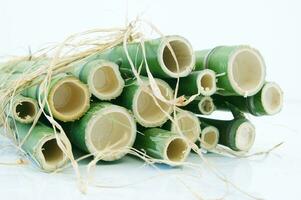 a bunch of bamboo sticks tied together with twine photo