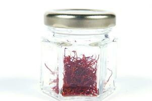 a pile of red saffron on a white background photo