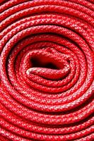 a pile of red fire hoses photo