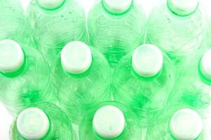 plastic bottles are scattered on a white surface photo