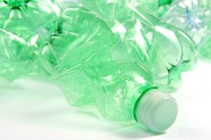 plastic bottles are scattered on a white surface photo