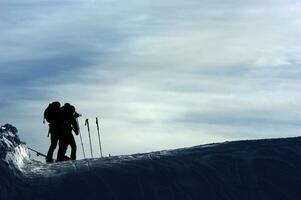 a group of people standing on a snow covered slope photo