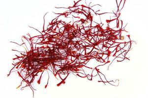 a pile of red saffron on a white background photo