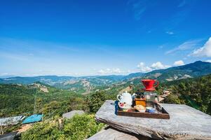 Beautiful mountain view and blue sky with coffee on the the balcony at doi sky nan province.Nan is a rural province in northern Thailand bordering Laos photo