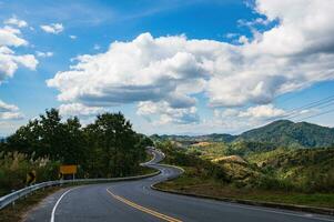 Road No.1081 way from Pua District to Bo Kluea District, Nan THAILAND.The famous view point and that tourists must stop by to check in at nan. Curvy road looks like number 3. photo