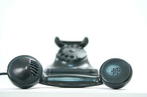 a black telephone on a white background photo