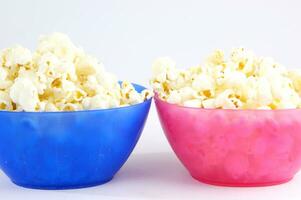 four colorful bowls of popcorn on a white surface photo