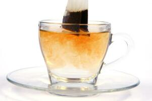 a glass cup with a tea bag in it photo