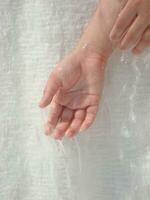 a person holding a plastic bag over their hand photo