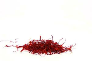 a pile of red saffron on a white background photo