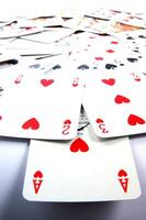 a pile of playing cards on a table photo