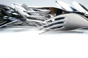 a bunch of silver forks and knives photo