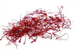 a pile of red saffron on a white background photo