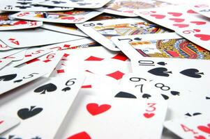 a pile of playing cards on a table photo