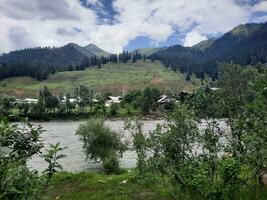 Scenic view of the natural beauty of Tao Butt, Neelum Valley, Kashmir.  Tao Butt is famous for its lush green trees and natural beauty. photo