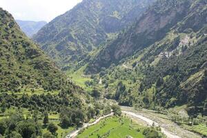 Beautiful day time view of Keran Valley, Neelam Valley, Kashmir. Green valleys, high mountains and trees are visible. photo