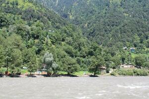 Beautiful day time view of Keran Valley, Neelam Valley, Kashmir. Green valleys, high mountains and trees are visible. photo