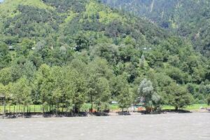 Beautiful day time view of Keran Valley, Neelam Valley, Kashmir. Green valleys, high mountains and trees are visible. photo