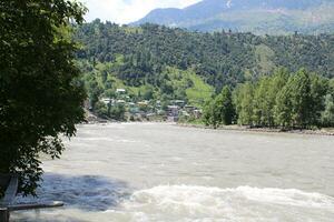 Beautiful day time view of Keran Valley, Neelam Valley, Kashmir. Green valleys, high mountains and trees are visible. photo