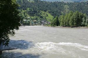 Beautiful day time view of Keran Valley, Neelam Valley, Kashmir. Green valleys, high mountains and trees are visible. photo