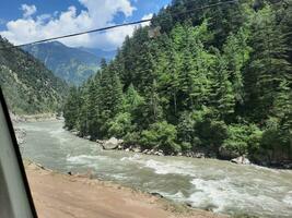 Beautiful day time view of Keran Valley, Neelam Valley, Kashmir. Green valleys, high mountains and trees are visible. photo