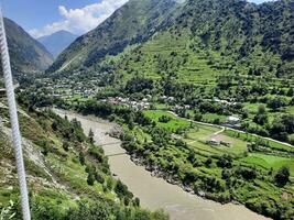 Beautiful day time view of Keran Valley, Neelam Valley, Kashmir. Green valleys, high mountains and trees are visible. photo