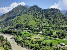 Beautiful day time view of Keran Valley, Neelam Valley, Kashmir. Green valleys, high mountains and trees are visible. photo