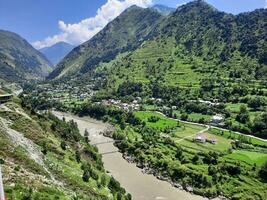 Beautiful day time view of Keran Valley, Neelam Valley, Kashmir. Green valleys, high mountains and trees are visible. photo