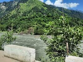 Beautiful day time view of Keran Valley, Neelam Valley, Kashmir. Green valleys, high mountains and trees are visible. photo