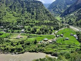 Beautiful day time view of Keran Valley, Neelam Valley, Kashmir. Green valleys, high mountains and trees are visible. photo