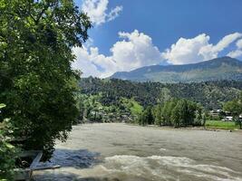 Beautiful day time view of Keran Valley, Neelam Valley, Kashmir. Green valleys, high mountains and trees are visible. photo