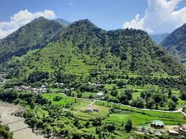 Beautiful day time view of Keran Valley, Neelam Valley, Kashmir. Green valleys, high mountains and trees are visible. photo