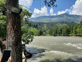 Beautiful day time view of Keran Valley, Neelam Valley, Kashmir. Green valleys, high mountains and trees are visible. photo