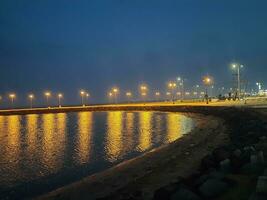 Beautiful morning view of Al Qunfudhah Beach, Saudi Arabia. The lights on the beach are creating a beautiful scene in the morning. photo