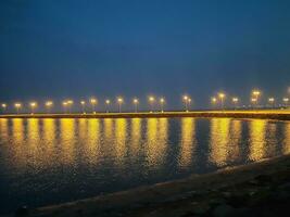 Beautiful morning view of Al Qunfudhah Beach, Saudi Arabia. The lights on the beach are creating a beautiful scene in the morning. photo