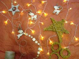 Getting ready for Christmas or New Year holiday. Flat-lay of decorations, ribbons, gift paper, door wreath photo