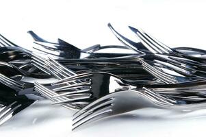 a bunch of silver forks and knives photo