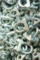 a pile of metal clips and nuts in a pile photo