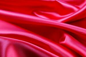 a close up of a bright pink satin fabric photo