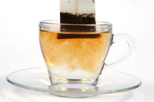 a glass cup with a tea bag in it photo