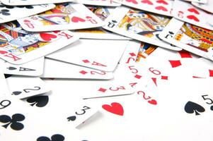 a pile of playing cards on a table photo