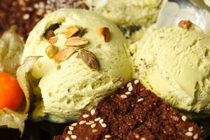 Pistachio ice cream topped with nuts photo