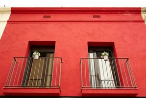 Two balconies on a red house photo