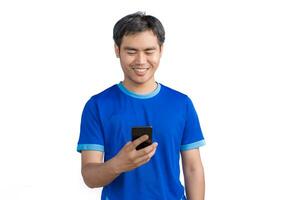 Happy man cheering excitedly in celebration after good news. Excited guy winner holding cellphone winning game online or investing trading, using mobile app celebrates victory success photo