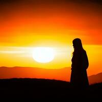 Silhouette of a lonely woman stands alone photo