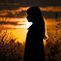 Silhouette of a lonely woman stands alone photo