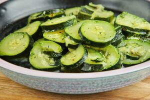 Zucchini cut into slices, steamed with herbs photo