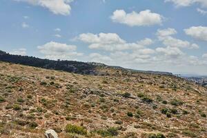 View of Haifa region on mountain slope against sky with clouds photo